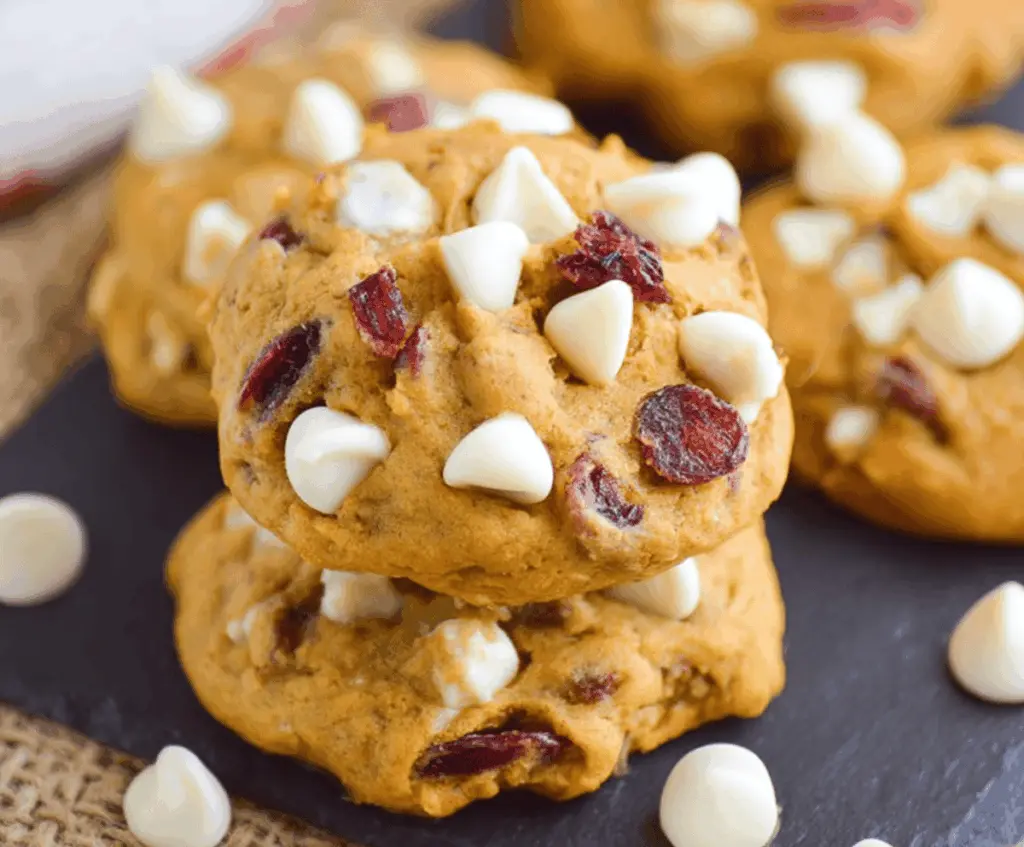 Delicious homemade Pumpkin Cranberry White Chocolate Cookies with fresh cranberries and white chocolate chunks on a baking sheet