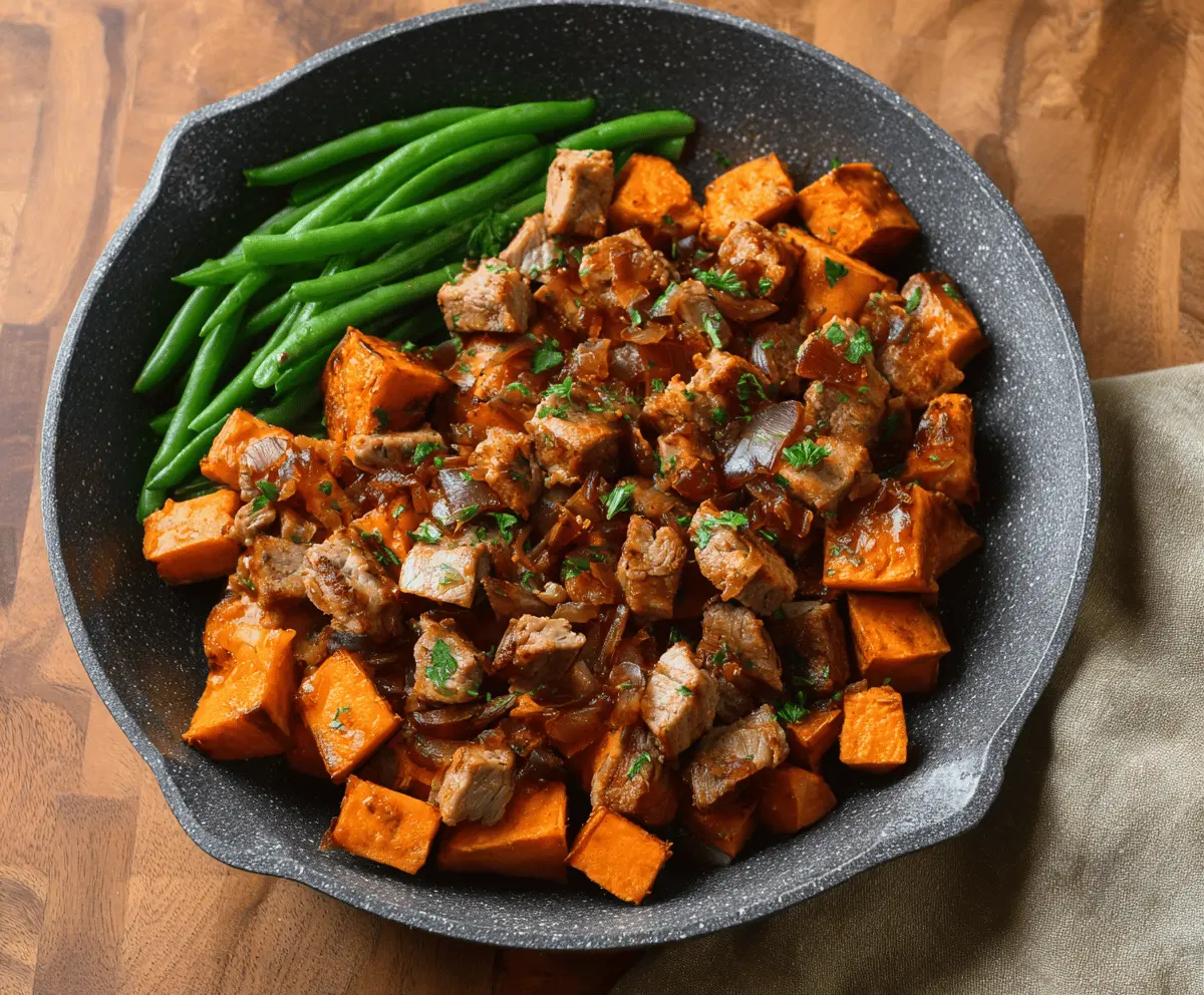 Delicious pork and sweet potato skillet with colorful vegetables, ready to serve, perfect for a healthy and hearty meal.