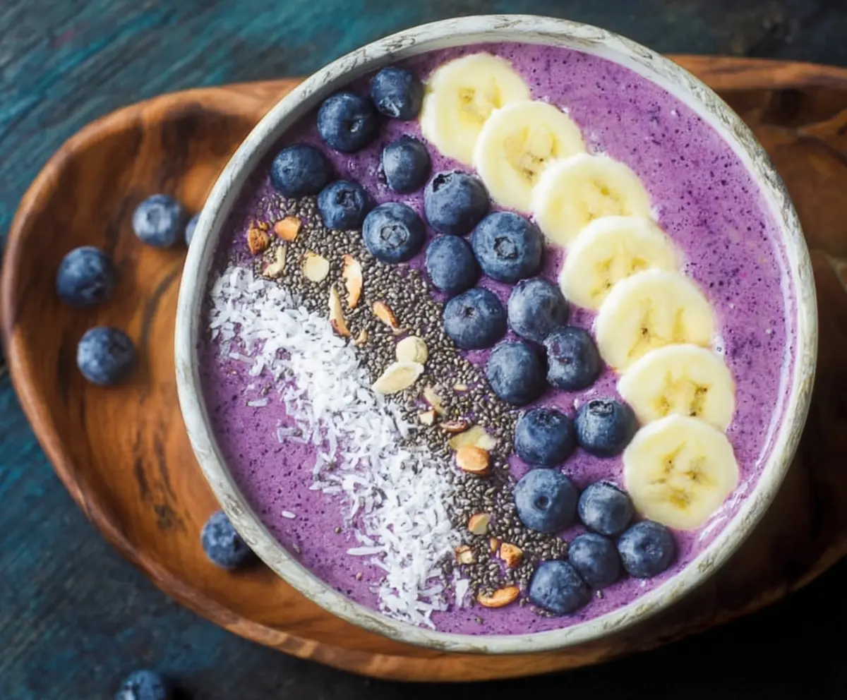 Healthy blueberry smoothie bowl topped with fresh berries and granola for a colorful breakfast