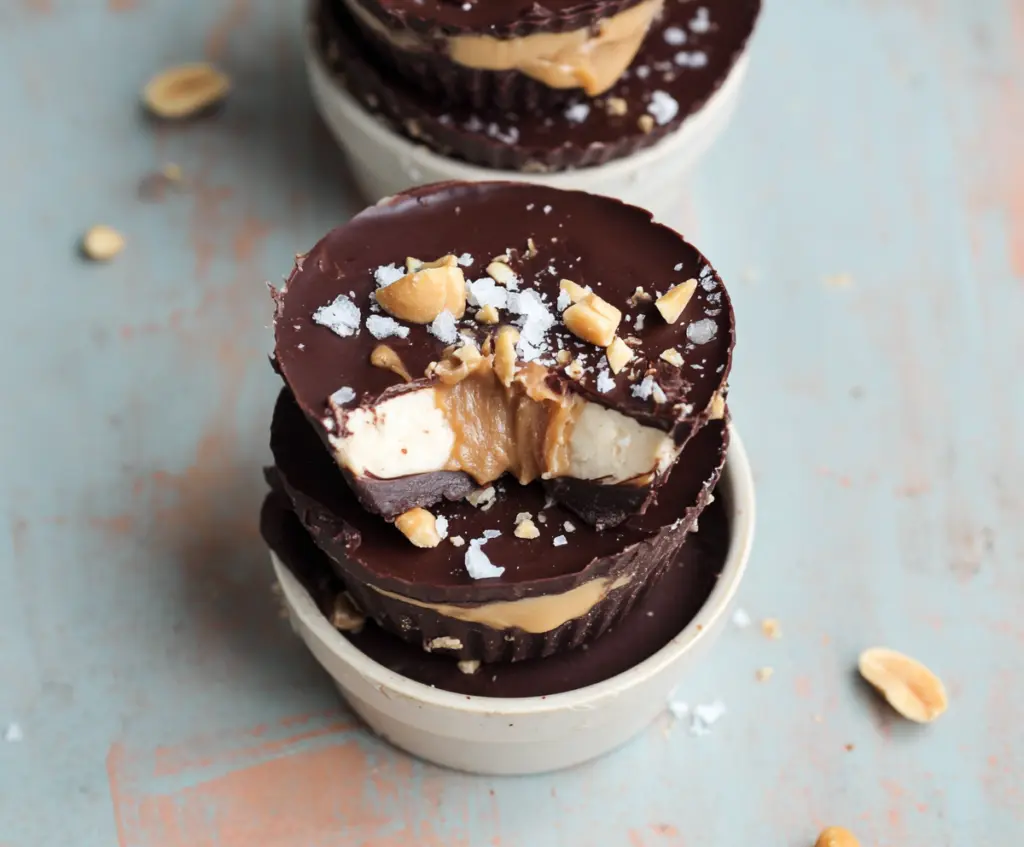 Creamy Greek yogurt peanut butter cups with a smooth chocolate coating, perfect for a healthy treat.