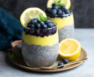 Delicious Lemon Blueberry Chia Pudding served in a glass with fresh blueberries and lemon slices.