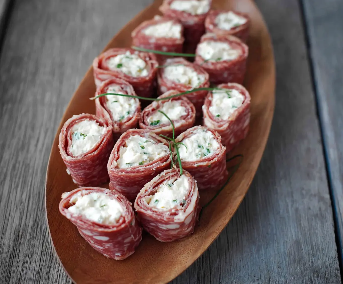 Delicious Salami & Cream Cheese Roll Ups on a platter, perfect for appetizers or snacks.