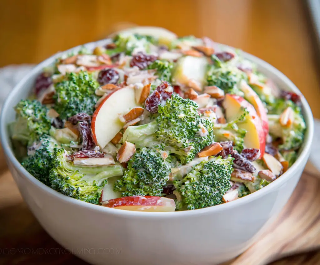 Fresh broccoli and crisp apple salad in a bowl, healthy and colorful recipe image.