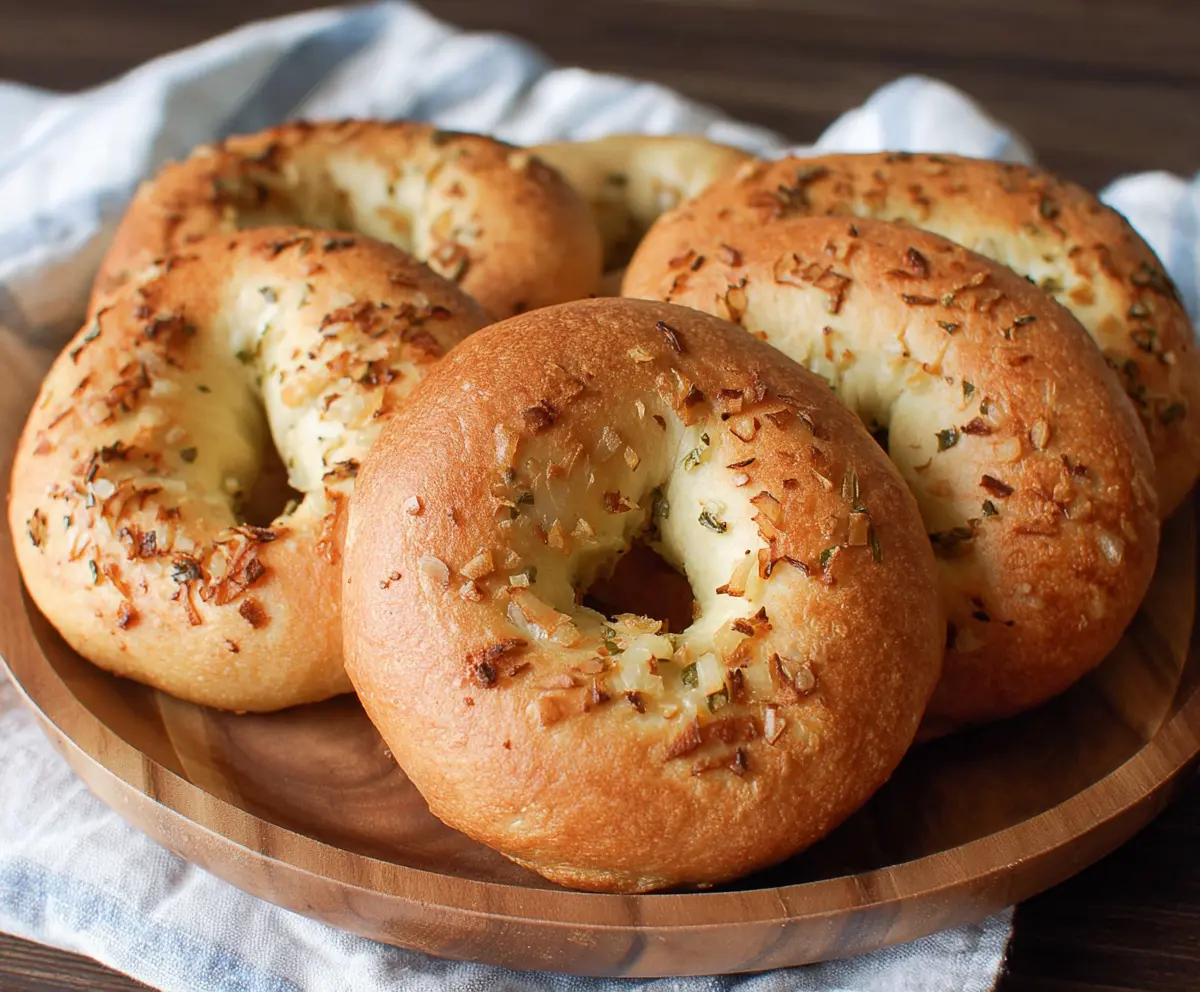 Freshly baked onion bagels with golden crust and rich onion flavor.