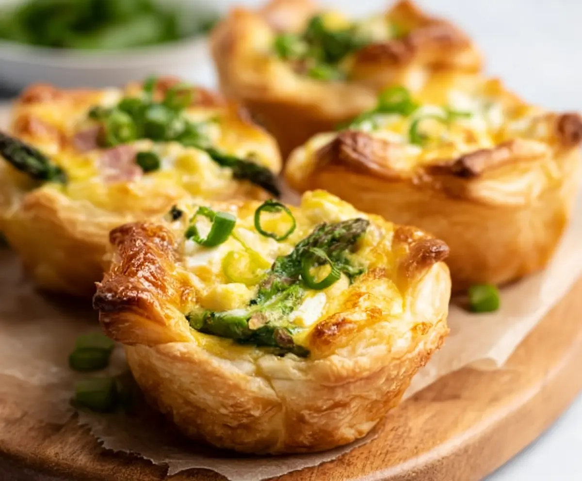 Delicious Easter Puff Pastry Quiche Cups filled with cheese, ham, and vegetables for a festive brunch.