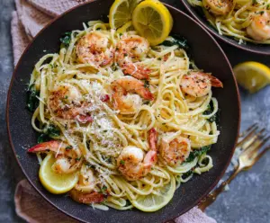 Delicious Lemon Garlic Shrimp Pasta served on a plate with fresh herbs.