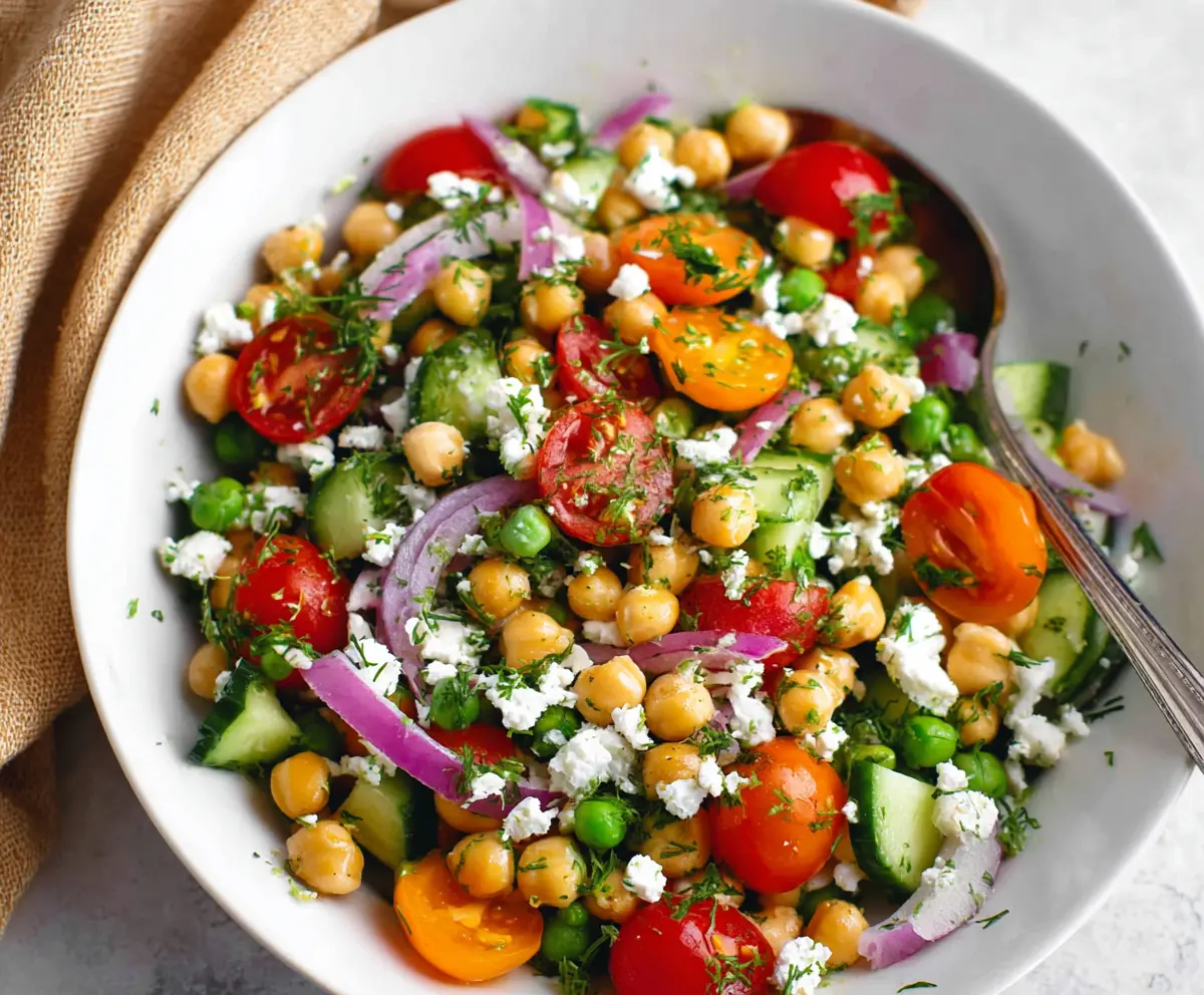 Fresh Mediterranean Pea Salad with colorful vegetables and herbs in a bowl